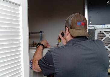 A tech working on a residential hot water heater