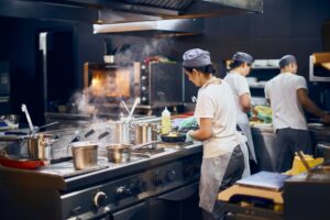 restaurant-cooks-preparing-food-in-commercial-kitchen
